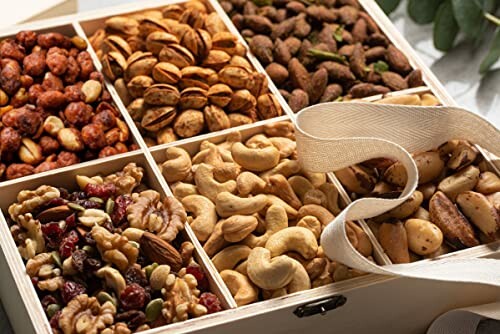 Assorted nuts in a wooden gift box with ribbon.